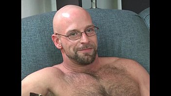 Bald gay man with chest hairs: a bear with a big cock