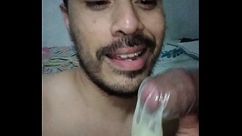  She jerks off her boy with a condom and then swallows the cum
